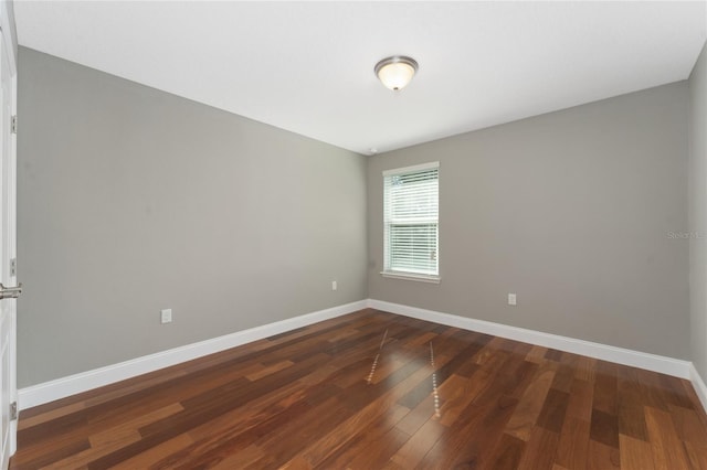 spare room featuring dark wood-type flooring