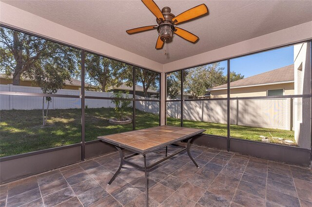 sunroom / solarium featuring ceiling fan