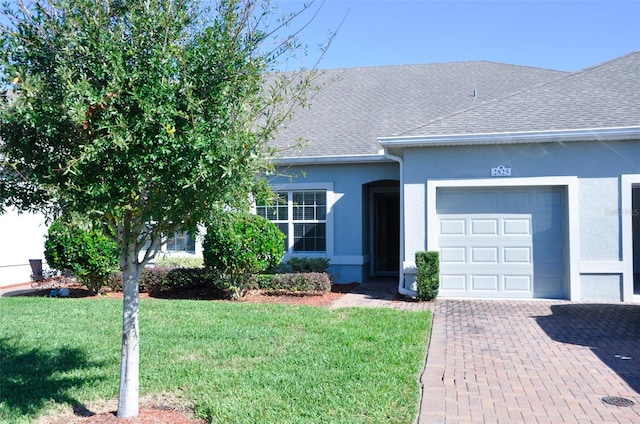 ranch-style house featuring a front lawn and a garage