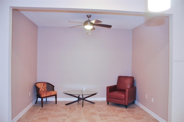 sitting room with light tile patterned floors and ceiling fan