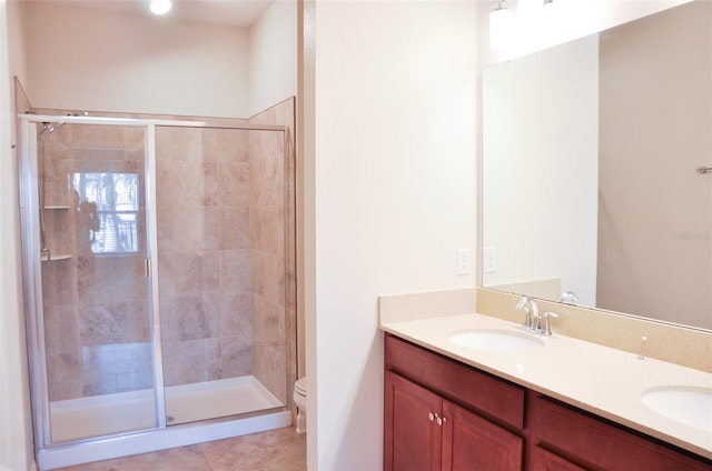 bathroom featuring tile patterned floors, vanity, toilet, and walk in shower