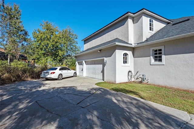 view of home's exterior featuring a lawn and a garage