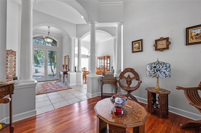 entryway featuring crown molding, french doors, and light hardwood / wood-style flooring