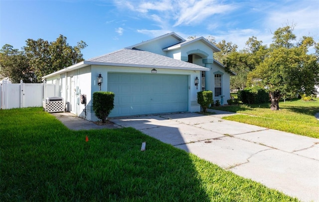 ranch-style house with a garage and a front lawn