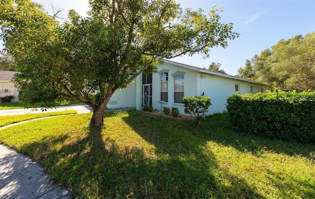 view of side of property featuring a yard