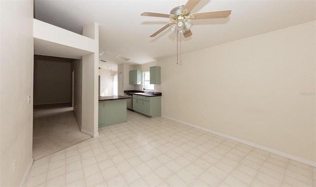 unfurnished room with ceiling fan and sink