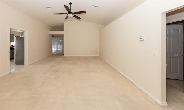 empty room with ceiling fan, lofted ceiling, and light carpet