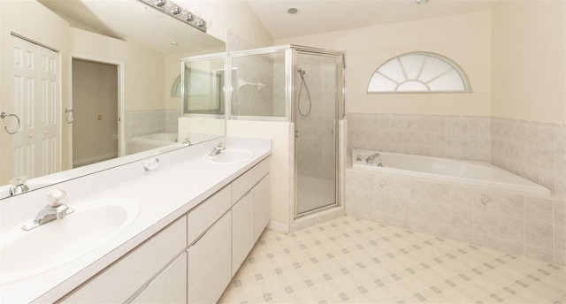 bathroom featuring vanity, separate shower and tub, and vaulted ceiling