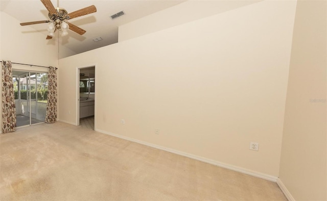 empty room featuring light colored carpet, high vaulted ceiling, and ceiling fan