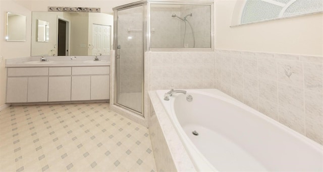 bathroom with vanity and independent shower and bath