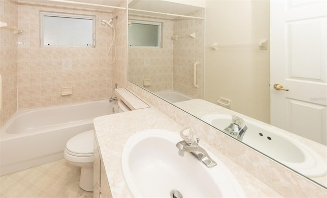 full bathroom with vanity, tiled shower / bath combo, and toilet