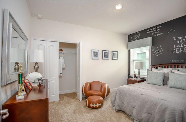 bedroom featuring light carpet and a closet