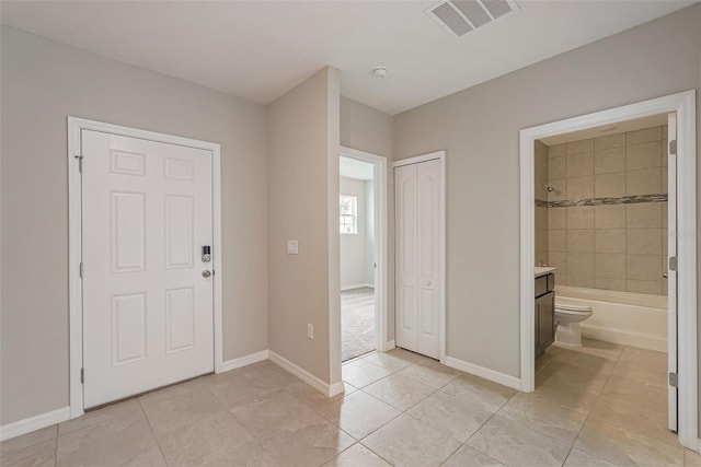 foyer entrance featuring light tile patterned flooring