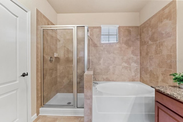 bathroom featuring tile patterned floors, plus walk in shower, and vanity