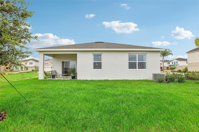 rear view of house featuring a patio, central AC unit, and a lawn