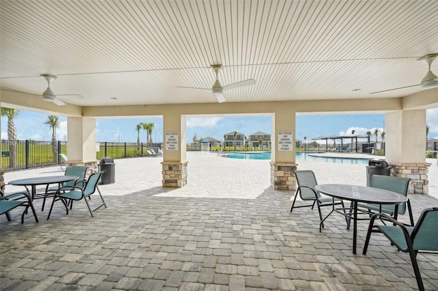 view of patio / terrace with ceiling fan and a community pool