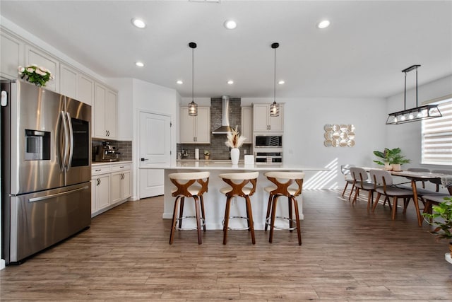 4381 Davos Dr, Clermont, FL 34711 - kitchen with stainless steel appliances, wall chimney range hood, decorative backsplash, light countertops, and white cabinets