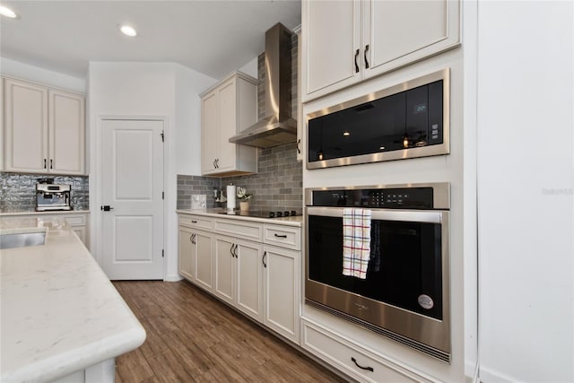 4381 Davos Dr, Clermont, FL 34711 - kitchen with stainless steel oven, wall chimney range hood, built in microwave, backsplash, and recessed lighting