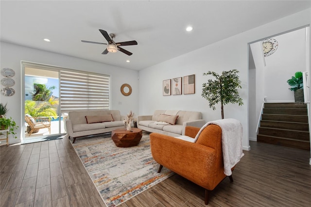 living room featuring ceiling fan and dark wood-type flooring