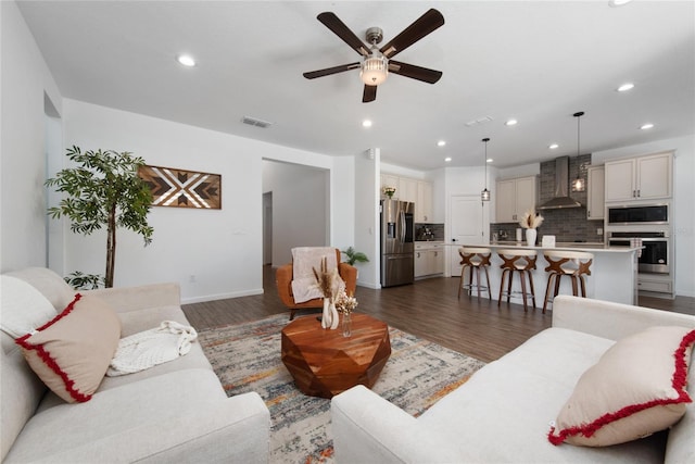 living room featuring dark hardwood / wood-style floors and ceiling fan