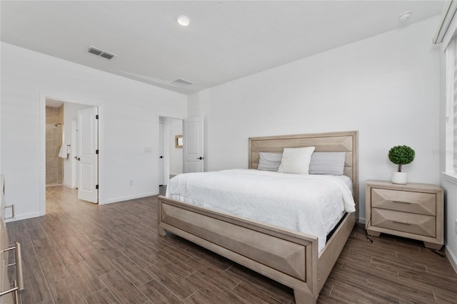 bedroom with dark hardwood / wood-style floors