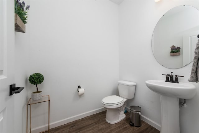 bathroom featuring sink, hardwood / wood-style floors, and toilet