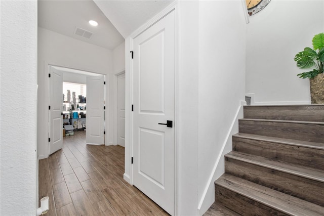 stairs with hardwood / wood-style flooring