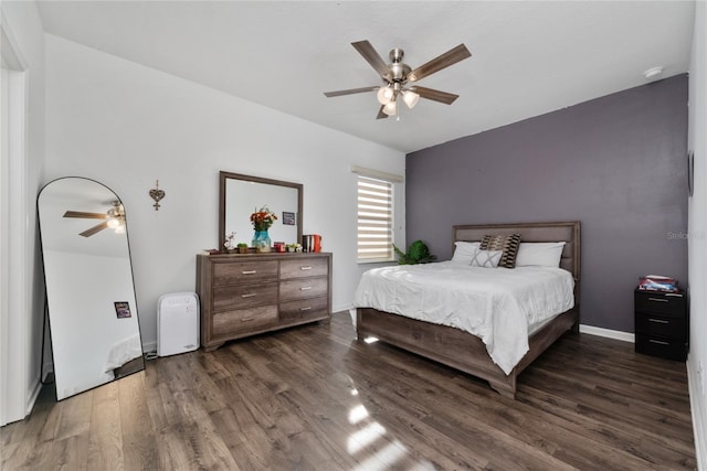 bedroom with dark hardwood / wood-style floors and ceiling fan