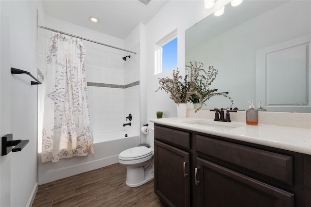 full bathroom with hardwood / wood-style floors, vanity, shower / bath combination with curtain, and toilet