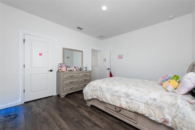 4381 Davos Dr, Clermont, FL 34711 - bedroom featuring dark wood-type flooring