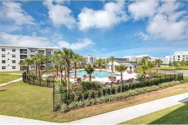 view of swimming pool featuring a lawn