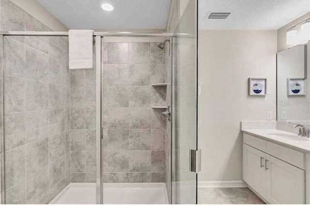 bathroom featuring vanity and a shower with shower door