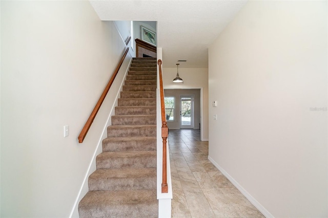 staircase featuring tile patterned flooring