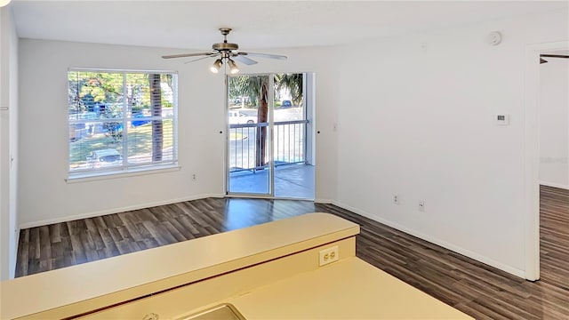 unfurnished room featuring dark hardwood / wood-style floors and ceiling fan