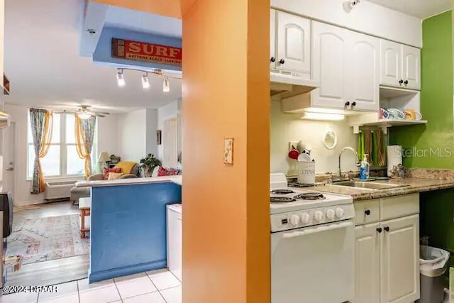 kitchen with white range with electric stovetop, a ceiling fan, under cabinet range hood, white cabinetry, and a sink