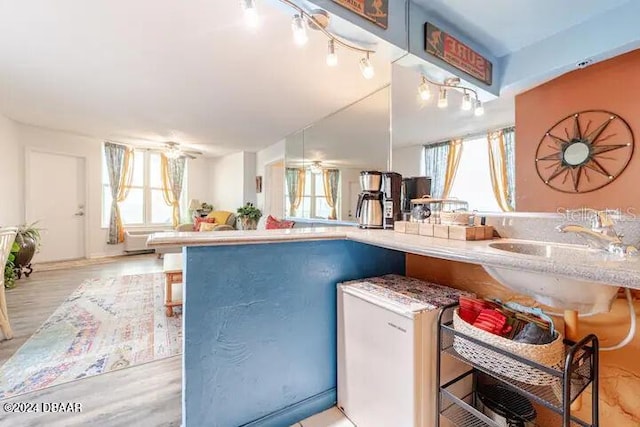 kitchen with a healthy amount of sunlight, light wood-style flooring, and open floor plan