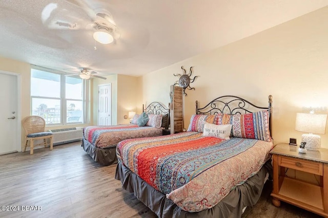 bedroom with a ceiling fan and wood finished floors