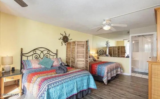 bedroom with a ceiling fan, ensuite bath, and wood finished floors