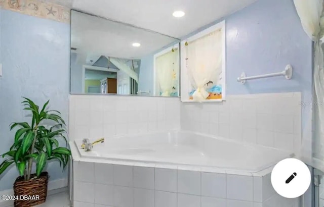 bathroom featuring a garden tub and recessed lighting