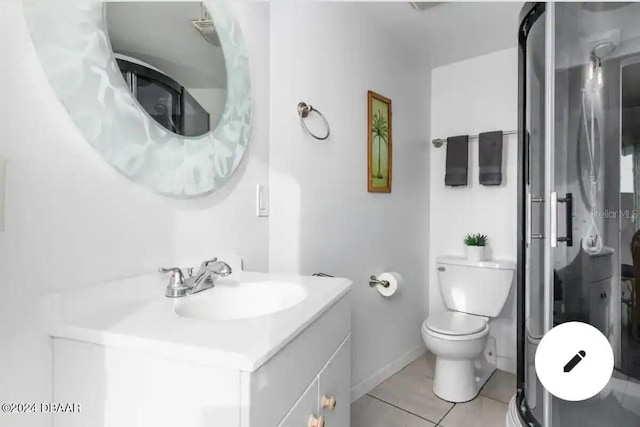 bathroom featuring toilet, vanity, baseboards, tile patterned floors, and walk in shower