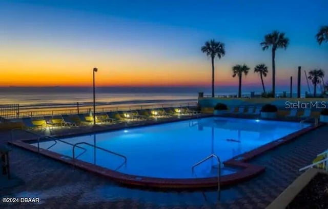 view of swimming pool featuring a water view