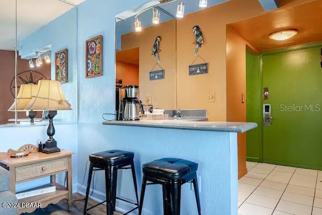 kitchen featuring a peninsula and tile patterned flooring