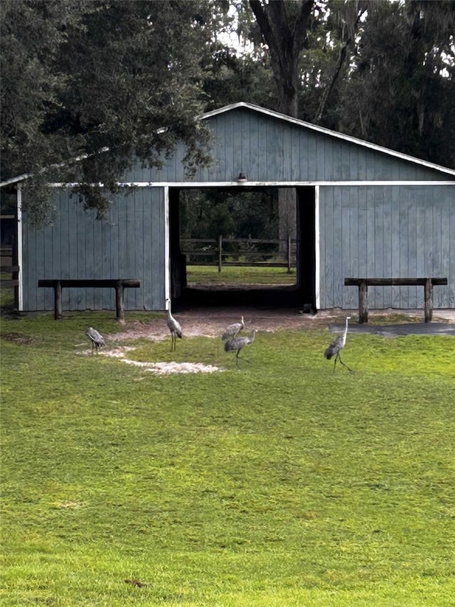 view of outbuilding featuring a yard