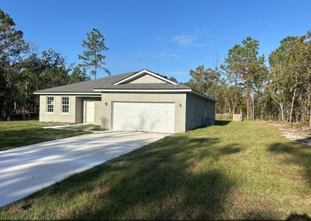 exterior space featuring a lawn, a garage, and central air condition unit