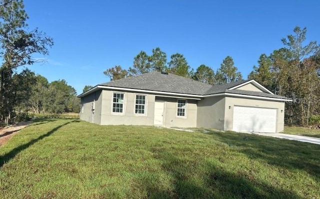 ranch-style home featuring a garage and a front lawn