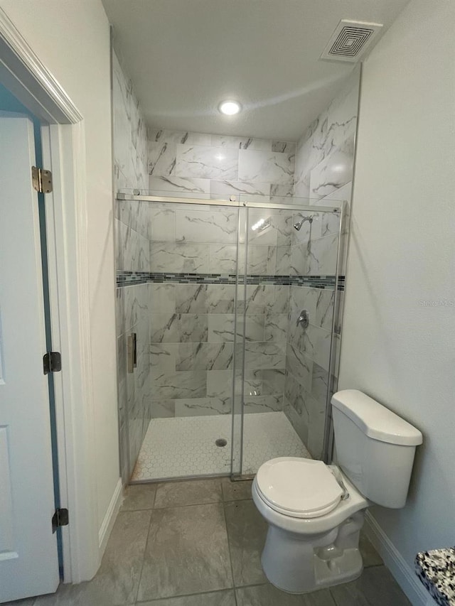 bathroom with toilet and an enclosed shower