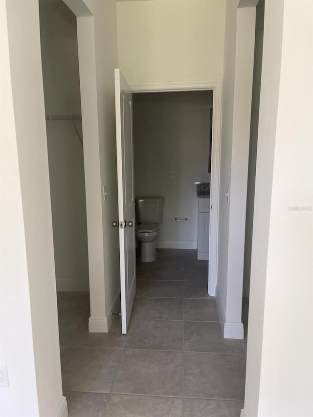 hallway featuring tile patterned flooring