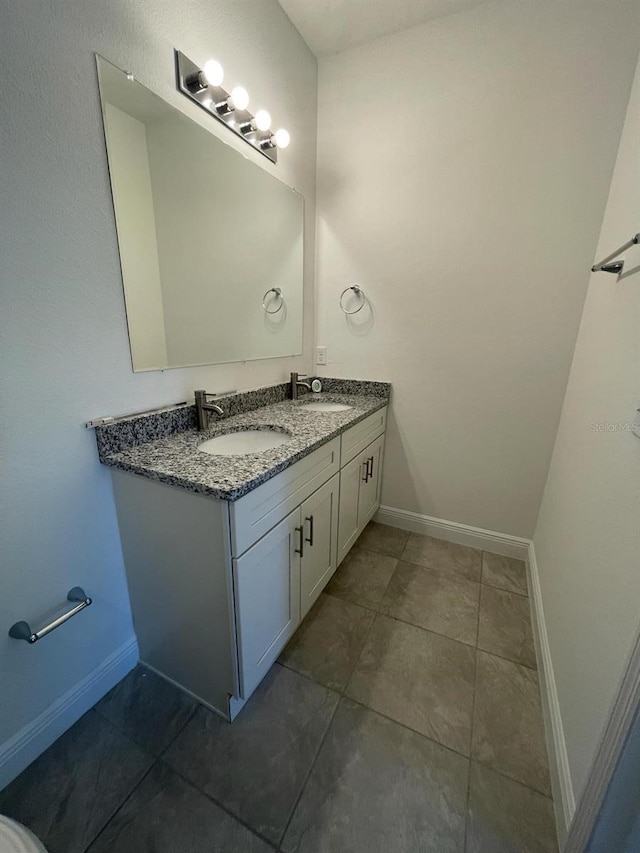 bathroom with tile patterned floors and vanity