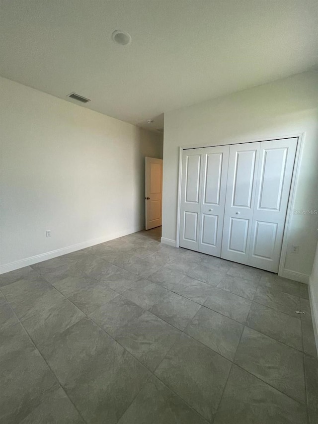 unfurnished bedroom with a closet