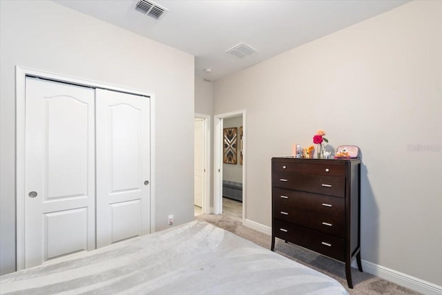 bedroom featuring light carpet and a closet